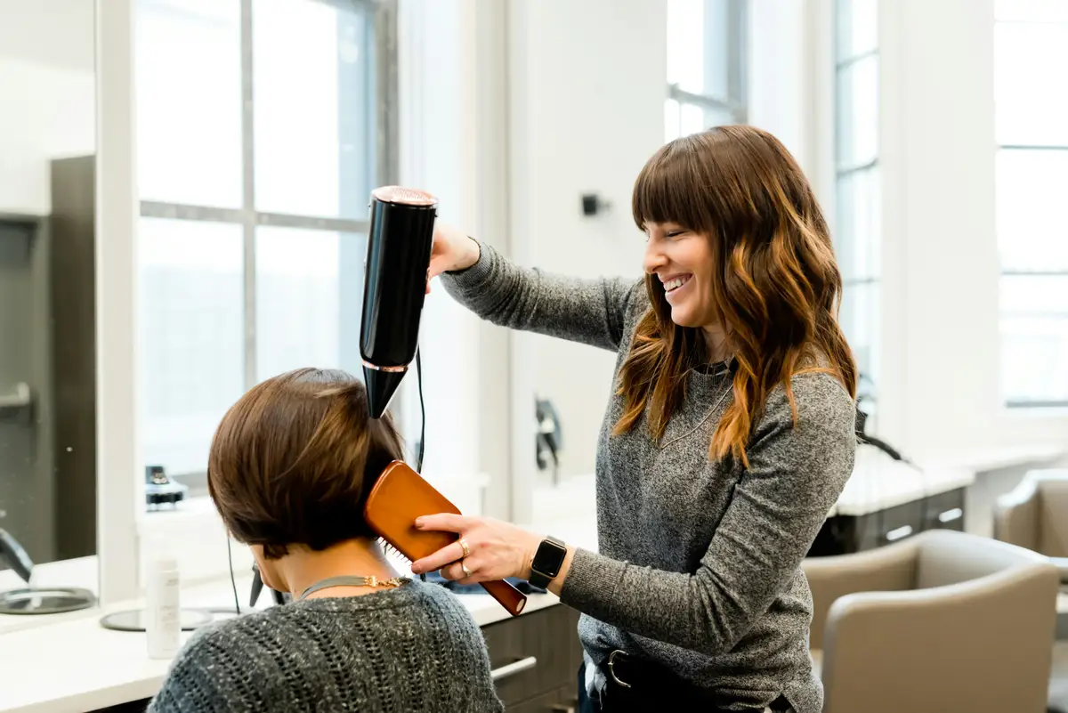 A professional attending a client in a bright studio.